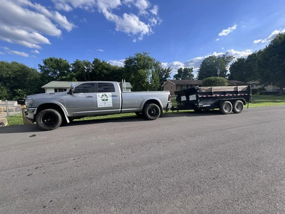 Cruz Control Property Solutions truck and dump trailer for junk removal services
